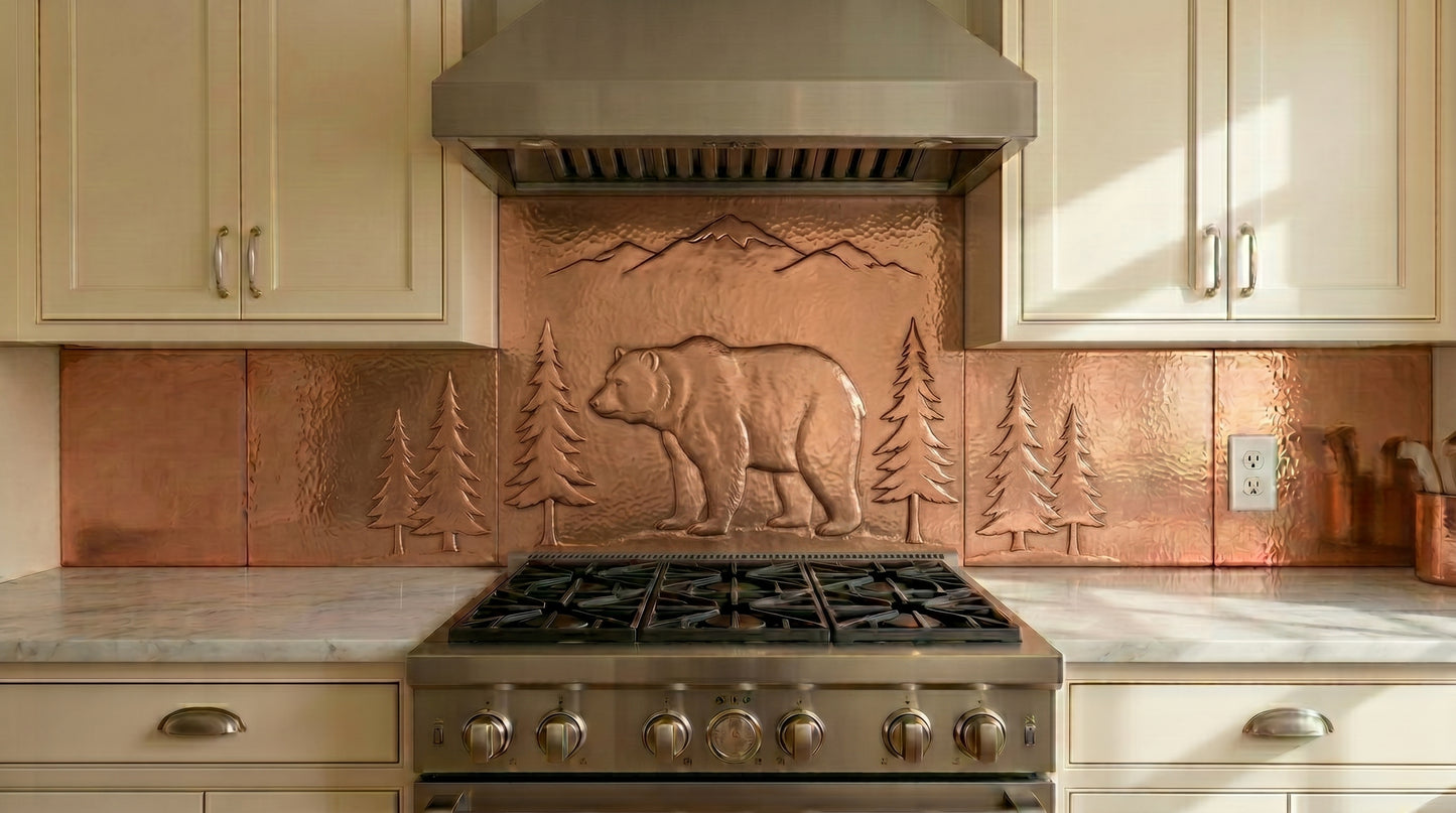 Handcrafted copper stove backsplash featuring a bear, pine forest, and mountain landscape. Real copper kitchen backsplash ideal for cabins, lodges, ranch homes, and rustic interiors. Custom sizes and finishes available for single panels or complete backsplash installations.