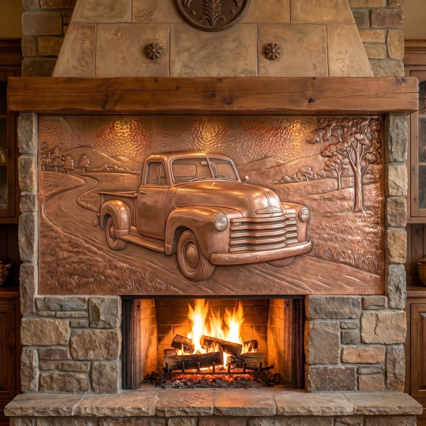 Hand-hammered classic truck wall art made from real copper, shown above a stone fireplace and featuring a vintage pickup on a winding country road with open fields, trees, and rolling hills in raised copper relief.