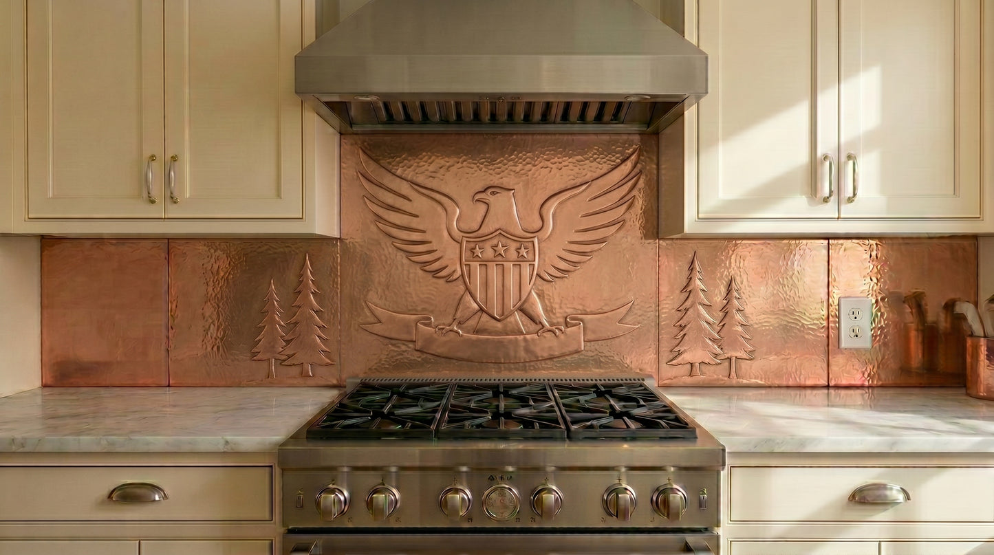 Handcrafted copper backsplash behind range featuring an American eagle relief design. Made from real copper for stove and cooktop areas. Custom sizes and finishes available for complete copper kitchen backsplash installations.