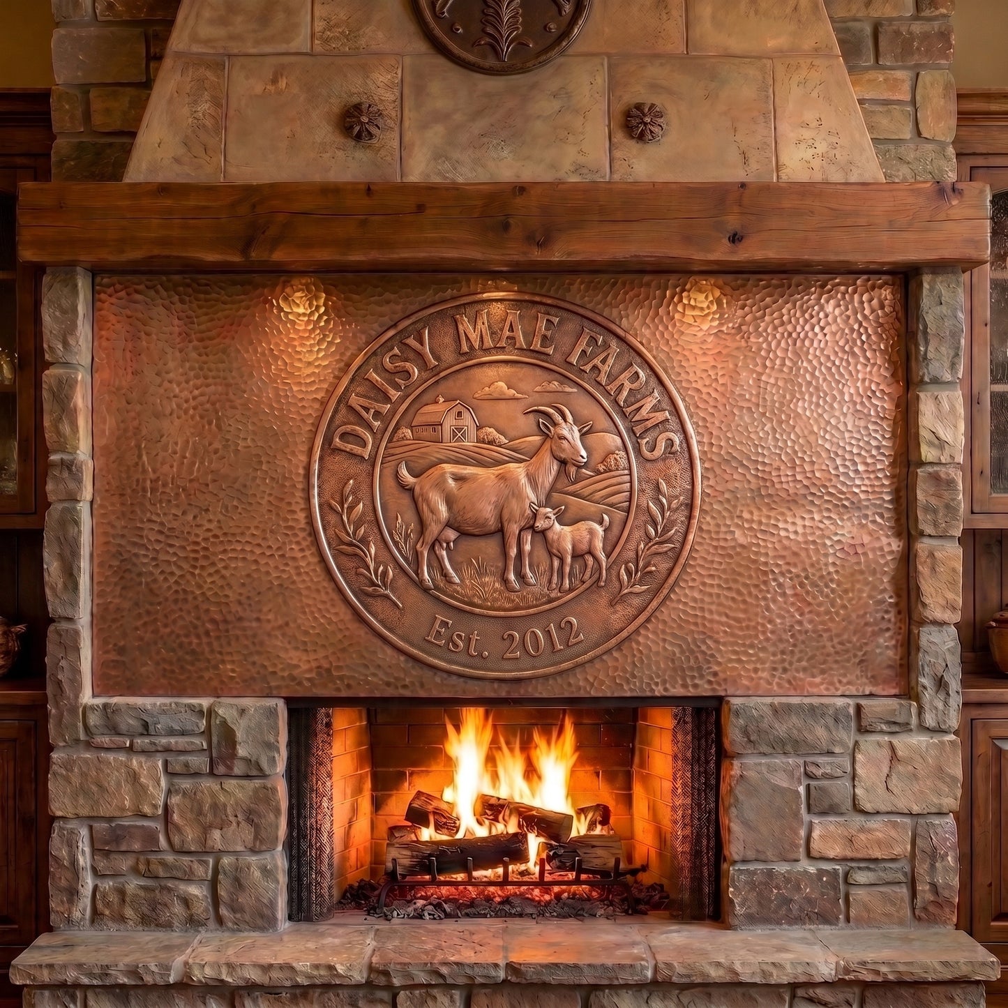 Hand-hammered custom goat farm logo made from real copper, displayed over a stone fireplace and featuring a doe and baby goat, barn and farm landscape, personalized Daisy Mae Farms name, established year, botanical details, and raised copper relief on a textured copper panel.