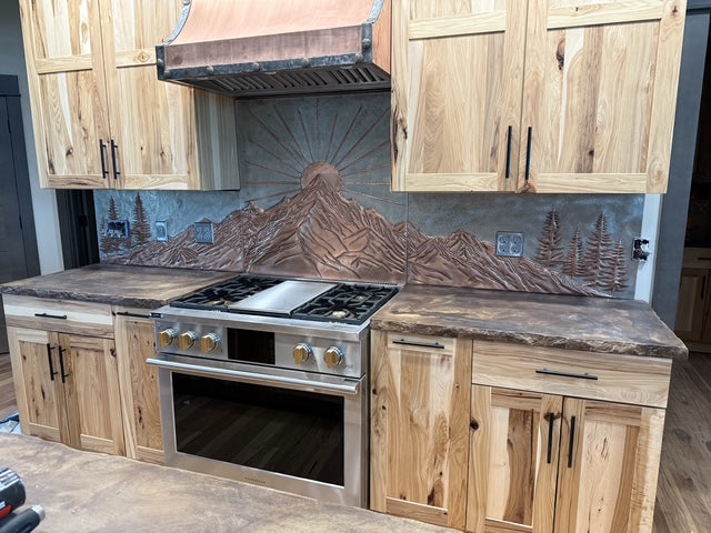 Hand-hammered copper kitchen backsplash set with mountain sunrise design