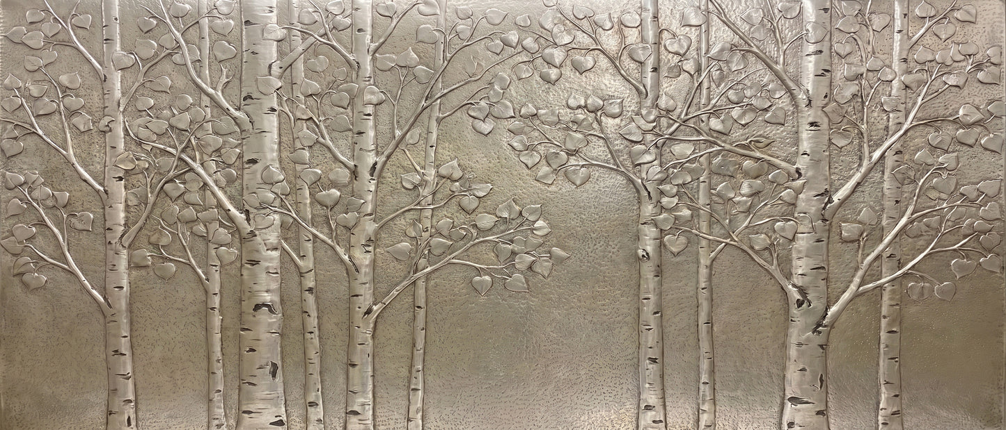 Quaking Aspen Grove metal backsplash design with hand-formed tree trunks, branches, heart-shaped leaves, and hammered background