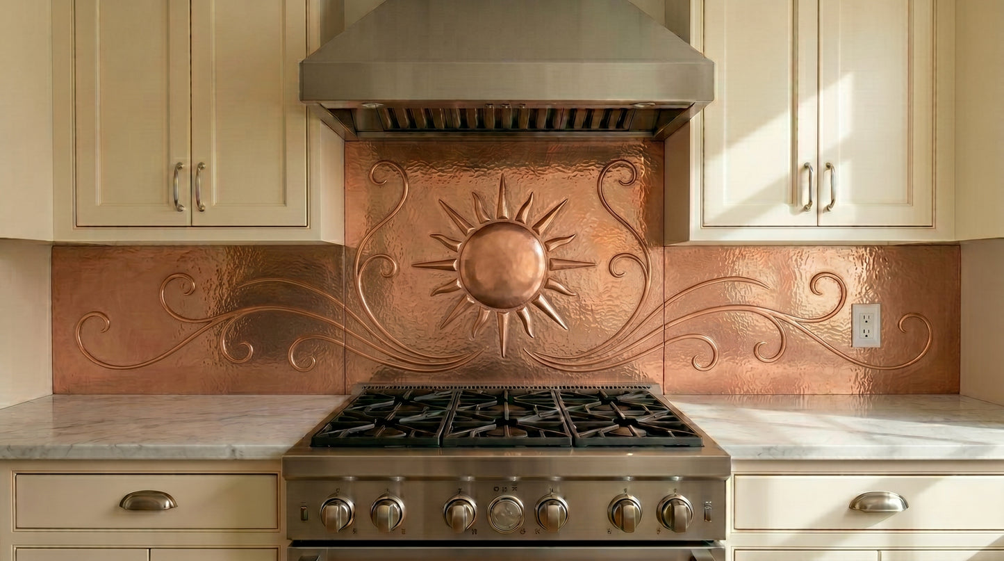 Handcrafted copper backsplash behind cooktop featuring a radiant sunburst and flowing scrollwork design. Custom made from real copper for luxury kitchens, cooktops, and cooking areas.