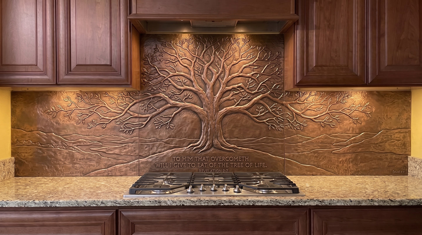 Handcrafted Tree of Life on a Hill copper kitchen backsplash inspired by Revelation 2:7, featuring a large spreading Tree of Life on elevated ground with an open landscape extending across the range wall and under-cabinet backsplash panels.
