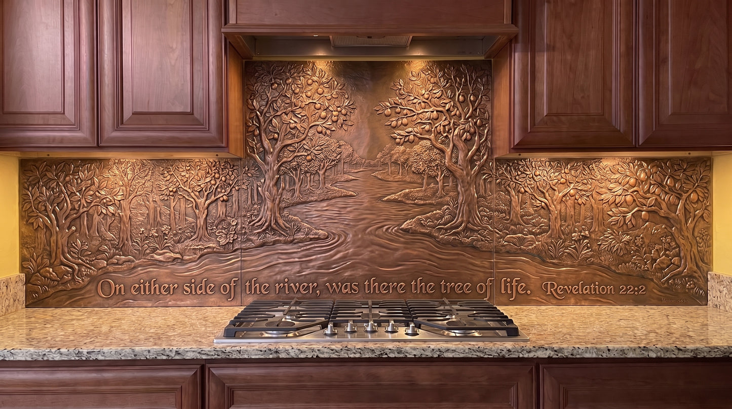 Two Banks of the River of Life copper kitchen backsplash inspired by Revelation 22:2, with a flowing river forming the center of the biblical landscape and abundant trees and foliage along both banks across the stove and under-cabinet backsplash panels.