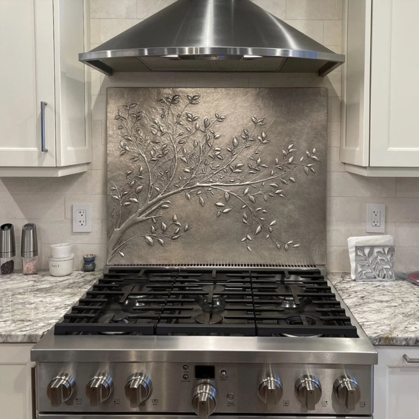 Modern Rustic Elegance with a Hand-Hammered Gray Copper Backsplash
The Rustic Kitchen Backsplash Tile - Copper Tree Branches - Gray Patina is a hand-hammered copper backsplash, blending organic beauty with modern industrial aesthetics. Designed for farmhouse kitchens, modern rustic spaces, and loft-style homes, this artisan-crafted copper tile features a detailed embossed tree branch design, creating a sophisticated focal point.
Each piece is individually handcrafted by skilled artisans, using thousands o