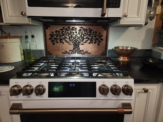 Copper backsplash with cream and ivory cabinets — timeless kitchen combination by Natuross