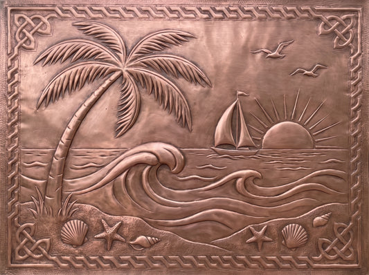 Handcrafted copper kitchen backsplash with palm tree, ocean waves, sailboat, sunset, and seashells