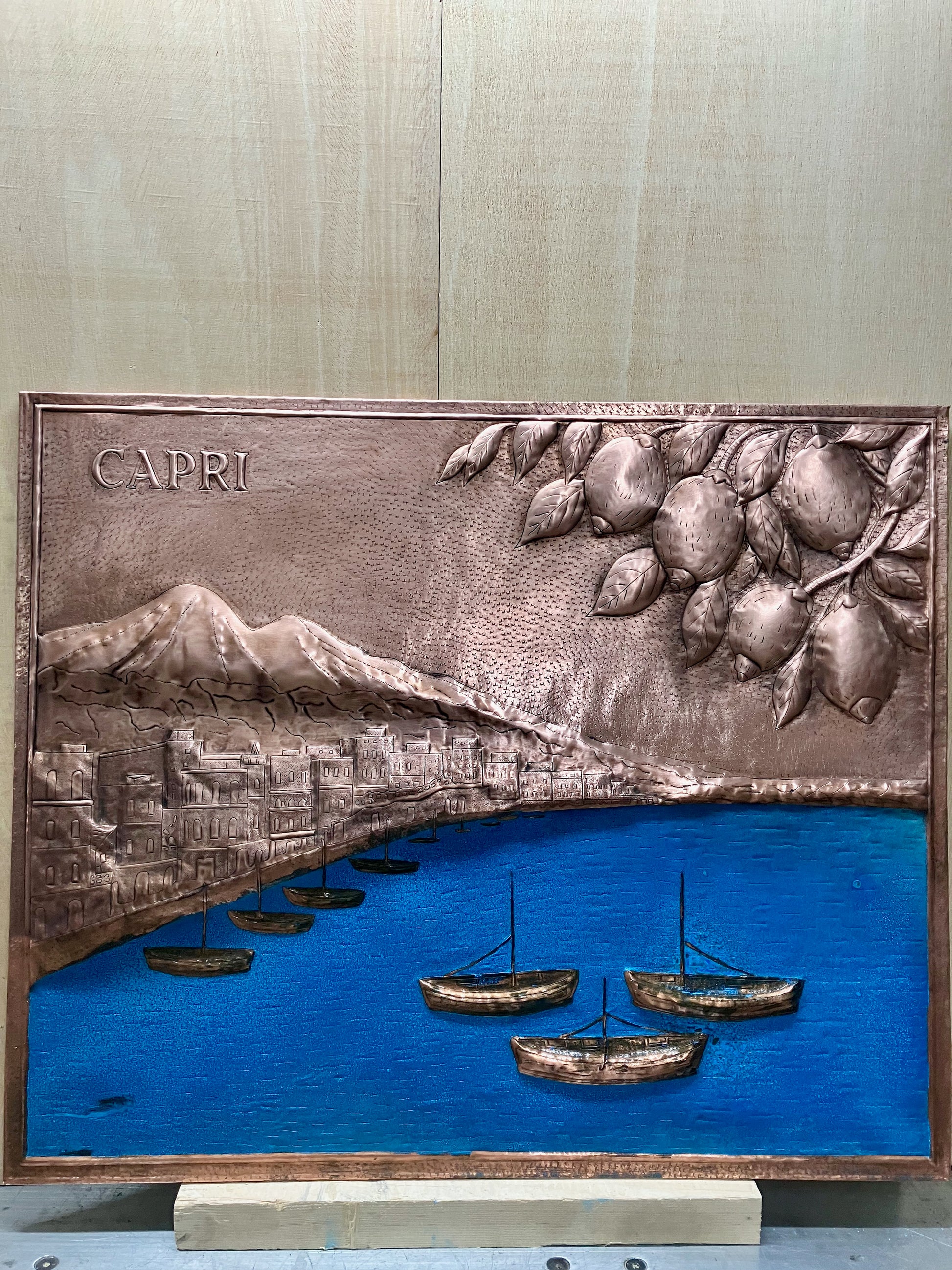 Capri Coast copper stove backsplash handcrafted from real copper. Italian coastal copper kitchen backsplash featuring Capri harbor, Mediterranean waters, boats, and lemon branches.