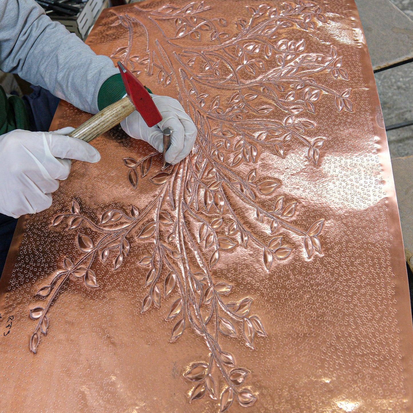 hand-hammering copper backsplash tile - tree branches