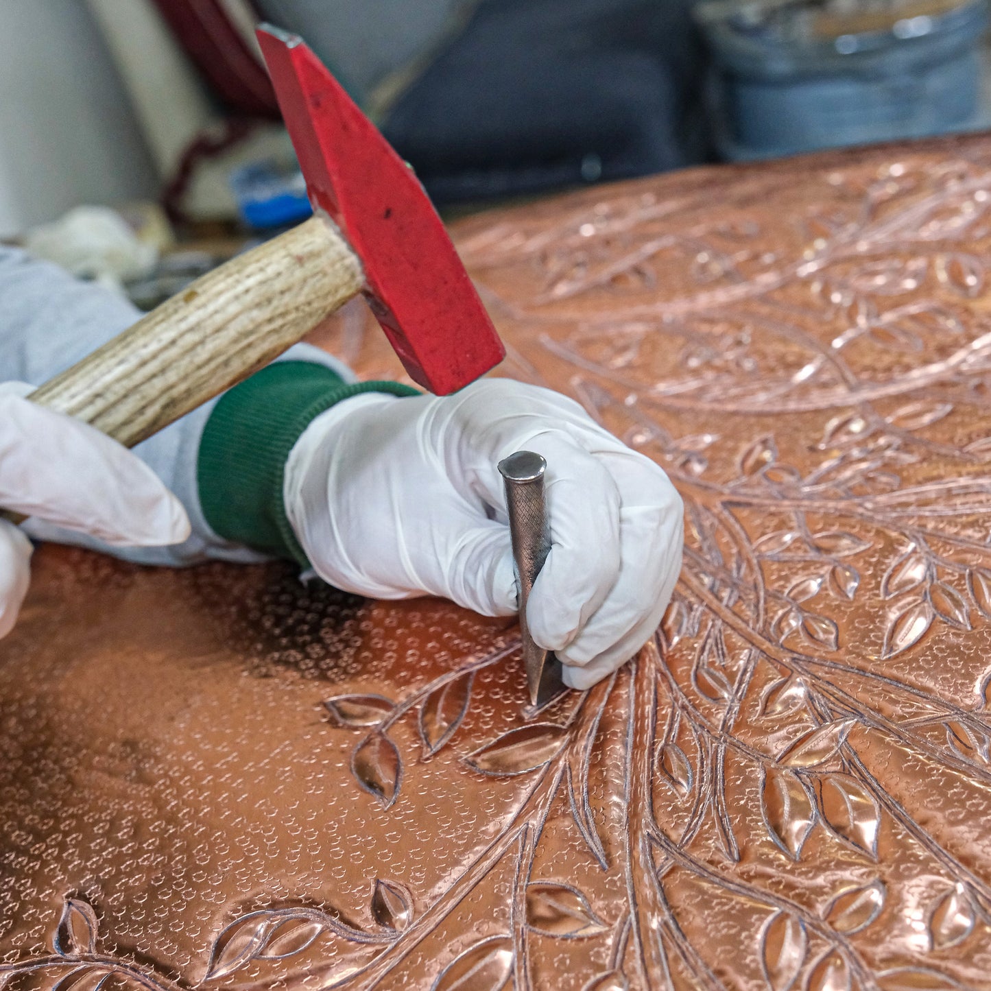 hand-hammering copper backsplash