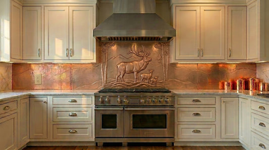 Handcrafted copper kitchen backsplash behind cooktop featuring a majestic elk family, mountain scenery, and woodland trees in raised copper relief. Made from real copper and custom built to order for rustic, lodge, ranch, cabin, mountain, and luxury kitchens. Available in custom sizes and finishes.