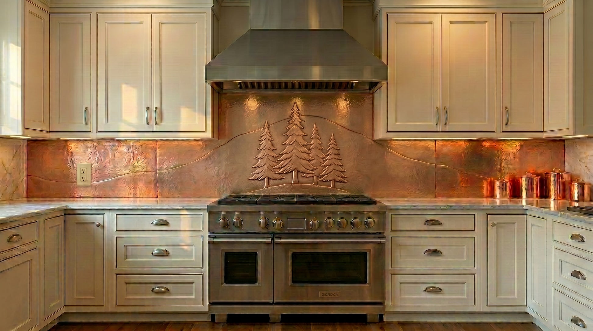 Handmade copper kitchen backsplash behind stove with pine tree design. Custom made to your size in 15 finishes. Real hand-hammered copper, made to order.