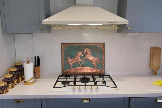 Kitchen stove with decorative tile featuring horses, surrounded by kitchen utensils and decor.
