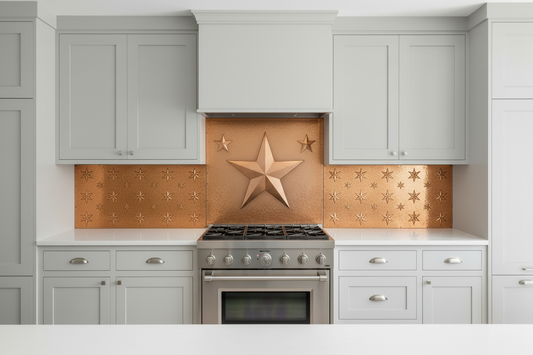 Three hand-hammered copper backsplash panels with 8-pointed star repoussé design installed in kitchen with hidden range hood — tall center panel with large bold star and wide side panels filling full wall with smaller supporting stars
