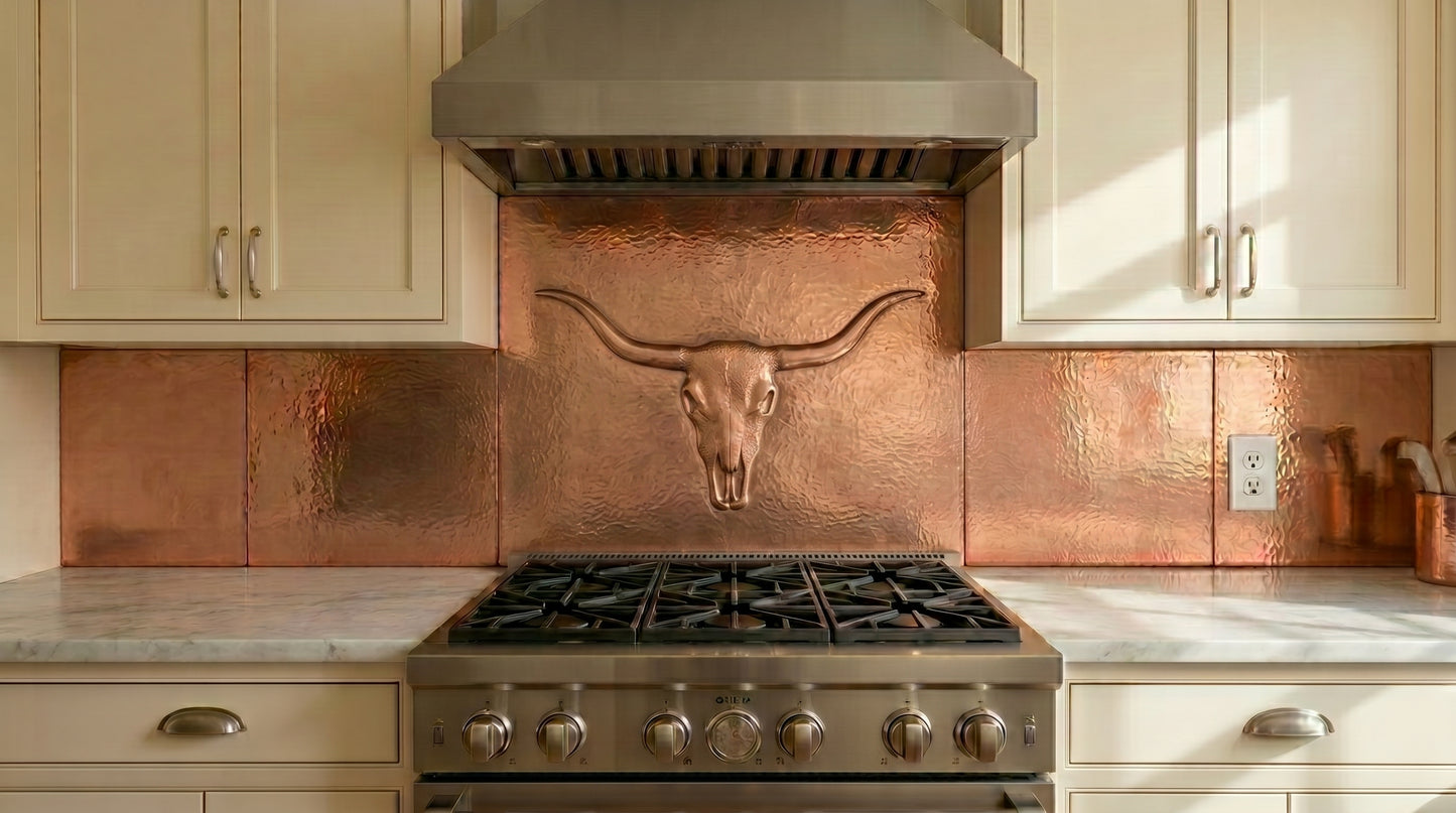 Handcrafted hand-hammered copper kitchen backsplash featuring a Western longhorn skull design. Real copper stove backsplash available in custom sizes and finishes for ranch, lodge, and Southwestern kitchens.