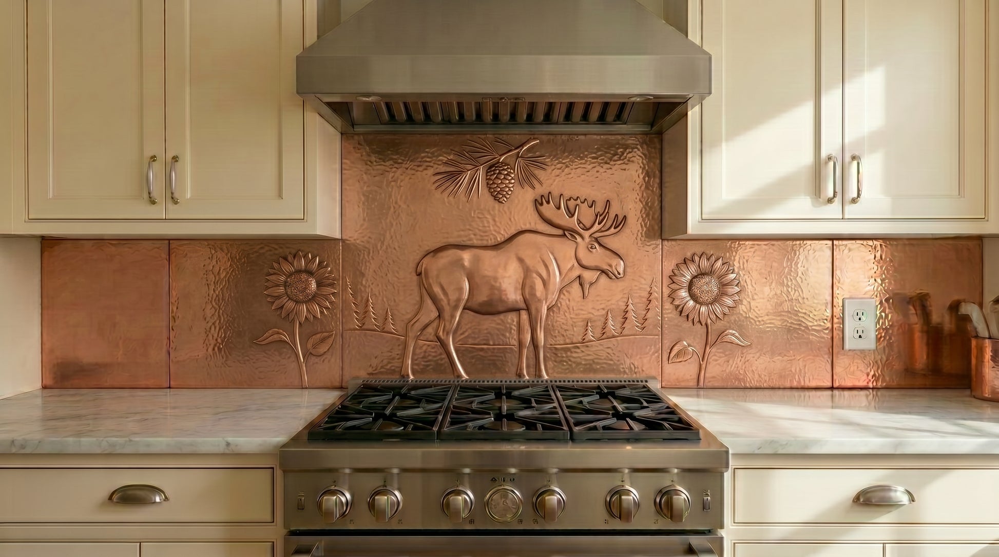 Handcrafted copper stove backsplash featuring a moose, sunflowers, and woodland details. Real copper kitchen backsplash for ranges and cooktops. Custom sizes and finishes available for single panels or complete copper backsplash installations.