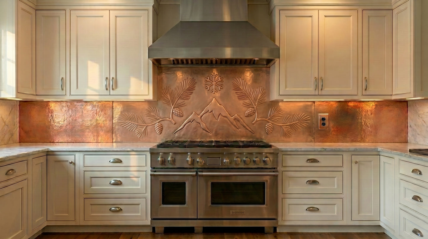 Custom fit copper kitchen backsplash featuring mountain peaks, pine branches, pinecones, and alpine-inspired artwork. Handmade from real copper for stove walls, range backsplashes, cabin kitchens, and custom kitchen installations.