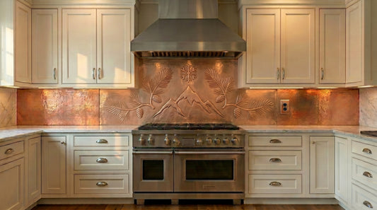 Custom fit copper kitchen backsplash featuring mountain peaks, pine branches, pinecones, and alpine-inspired artwork. Handmade from real copper for stove walls, range backsplashes, cabin kitchens, and custom kitchen installations.