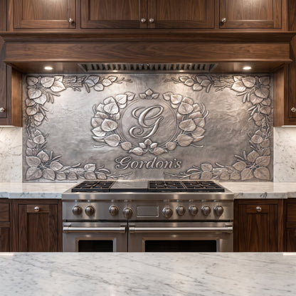 Personalized Quaking Aspen kitchen backsplash with custom monogram and family name installed behind a stainless steel range