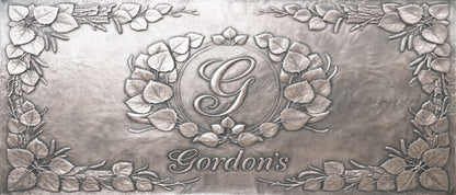 Personalized Quaking Aspen copper kitchen backsplash with custom family initial and name surrounded by raised aspen leaves and branches