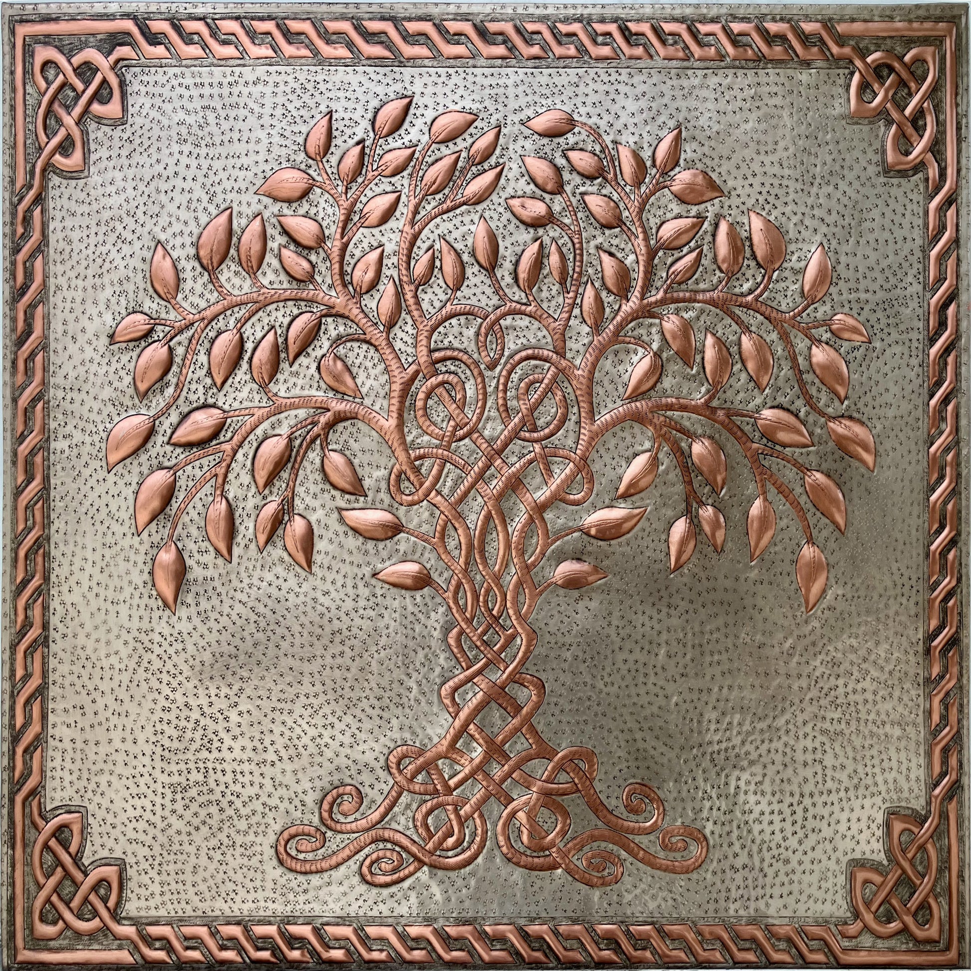 A square decorative wall plaque featuring a raised Celtic-style tree of life with copper-toned branches and leaves on a textured gray background, surrounded by an ornate braided border.