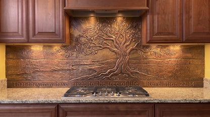 Tree of Life at Dawn copper kitchen backsplash inspired by Revelation 22:14, featuring a large Tree of Life beside living water with an open landscape and the impression of dawn formed through raised metalwork and textured copper across the range-wall backsplash.
