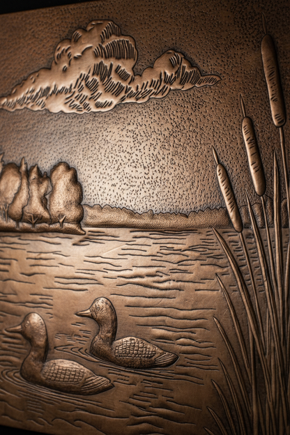 Close-up detail of brown patina lake scene showing raised relief ducks forest and hand-hammered aged copper texture