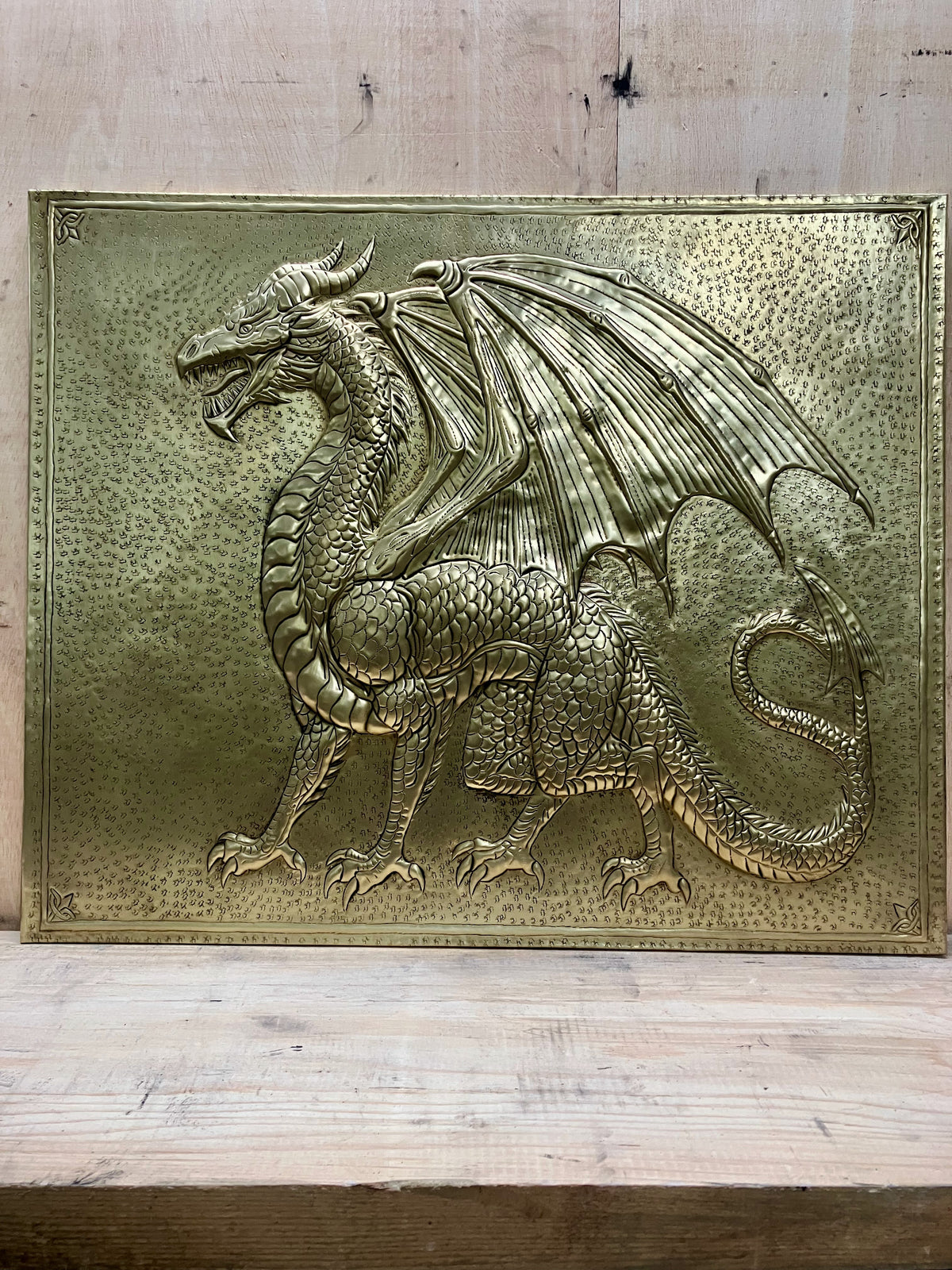 Handmade dragon brass kitchen backsplash for behind the stove. Custom fantasy wall decor for medieval homes, game rooms, libraries, and dragon lovers.