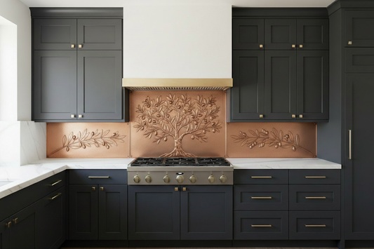 Three copper panels spanning full kitchen wall behind 36-inch range — complete olive tree with gnarled trunk, spreading branches, olive clusters and narrow leaves in repoussé relief on wide center panel matching hood width, single olive branch on each side panel, warm natural copper tone, fine stipple background, dark charcoal flat-front cabinets with brushed gold hardware, Calacatta marble countertop, modern luxury kitchen
