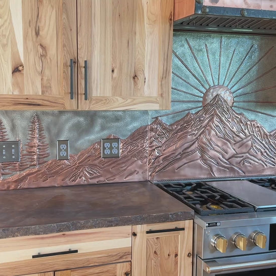 Video showing the hand-hammered Mountain Sunrise copper kitchen backsplash set with raised relief details, full-wall layout, and custom multi-panel design.